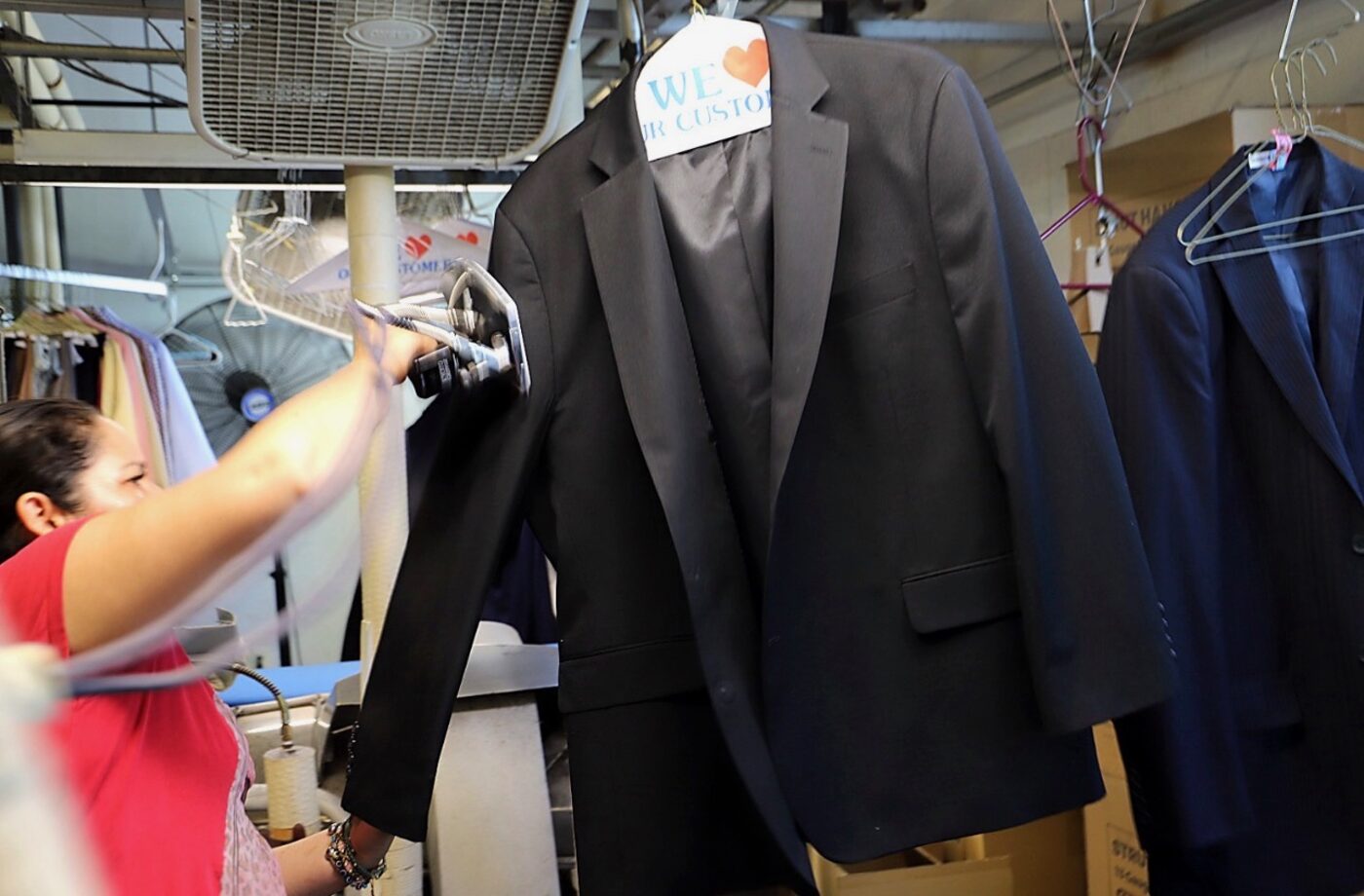 Steaming and finishing a suit jacket at KYM Amen Drycleaners