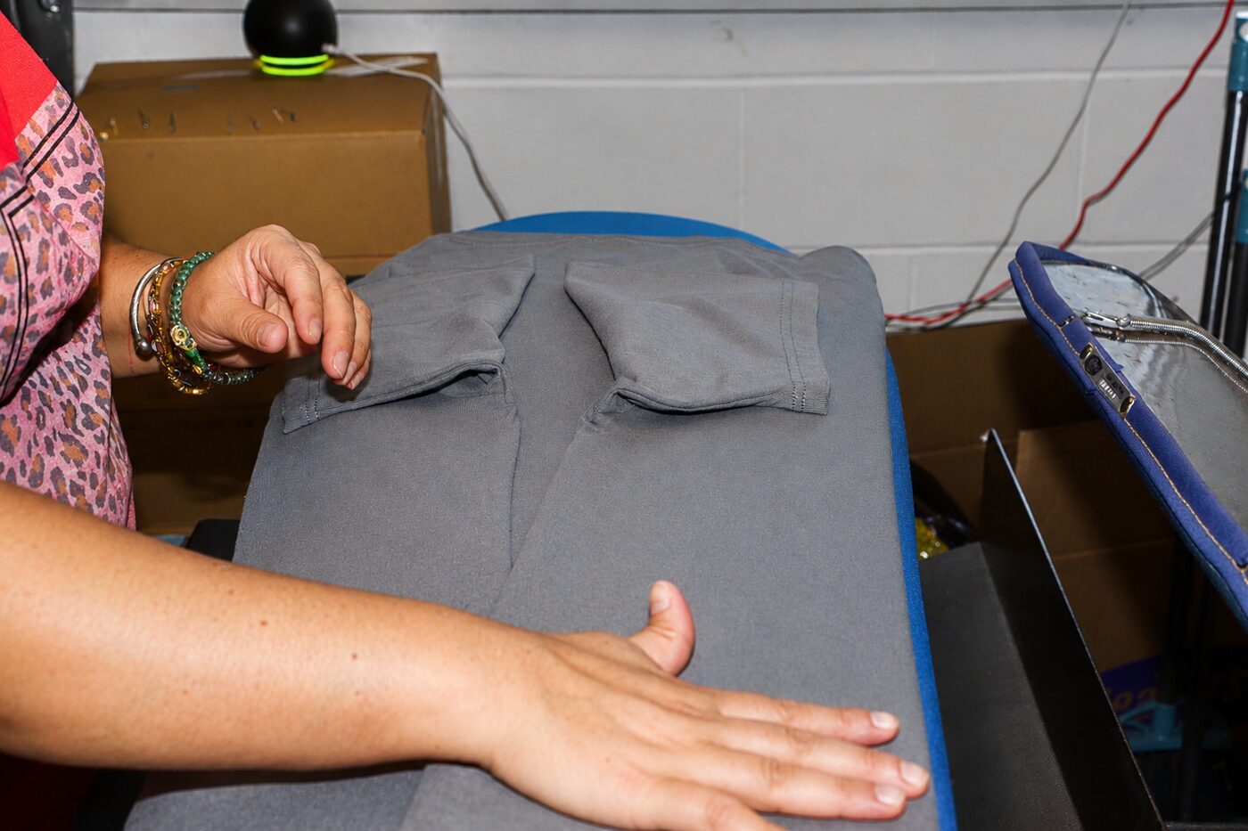 Pressing trousers on a professional press at KYM Amen
